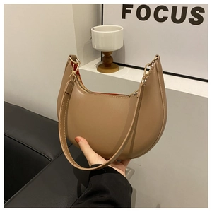 Close-up of khaki crescent hobo bag with smooth leather texture and gold hardware