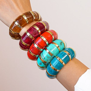 Detail of multi-color geometric acrylic bangles with gold-tone metal segments