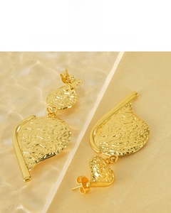 Detail of 18K gold plated earrings featuring a hammered leaf texture and vintage design