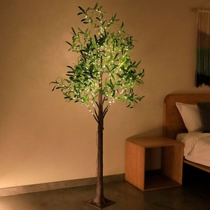 Artificial olive tree with warm LED lights in a cozy bedroom setting for home decor