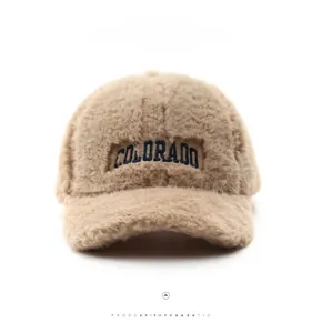 Detail of beige fuzzy plush baseball cap with blue Colorado letter embroidery