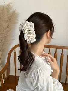 Close-up of beige floral print scrunchie used as a ponytail holder hair accessory