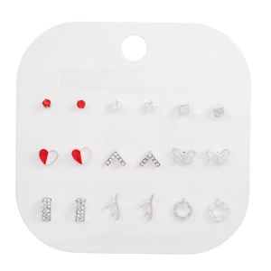 Detail of 9-pair silver stud earring set featuring heart, flower, and crystal designs