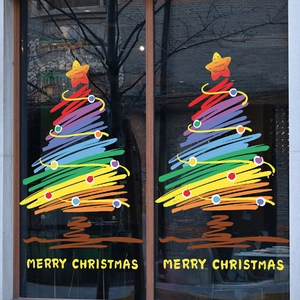 Detailed view of hand-painted rainbow Christmas tree window stickers with Merry Christmas text