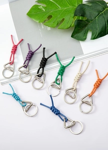 Macro detail of braided rope keychains in eight colors with silver metallic rings