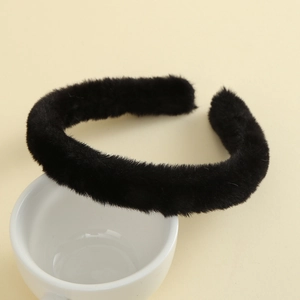 Close-up of soft black plush headband texture and thick faux rabbit fur material