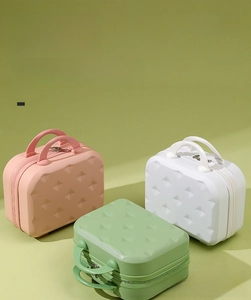 Close-up of three 14-inch mini cosmetic cases in pink, white, and green with diamond texture