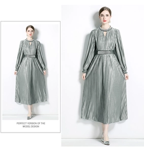 Detailed close-up of metallic pleated dress fabric and matching decorative waist belt
