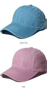 Detail shot of light blue and pink washed cotton baseball caps in high quality canvas texture