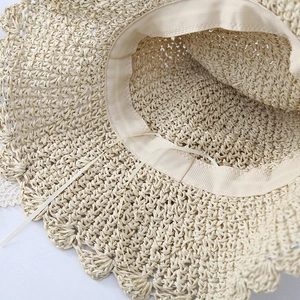 Macro detail of breathable straw weave texture and inner adjustable ribbon on summer beach hat