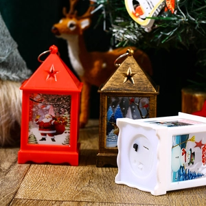 Detail of Christmas lantern base with power switch and festive Santa Claus patterns