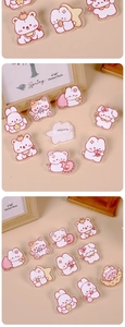 Close-up of cute acrylic animal brooches with rabbit and bear motifs on a warm beige background