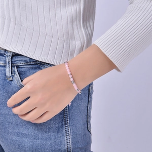 Detailed shot of pink crystal beaded bracelet with silver spacers on a model's wrist