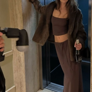 Detail of a brown two-piece set featuring a cropped camisole and drawstring midi skirt