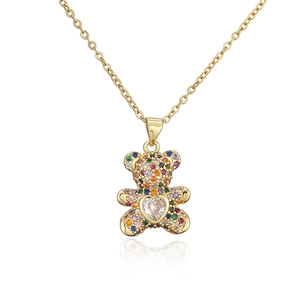 Detail of gold necklace featuring a bear pendant with colorful stones and heart zircon