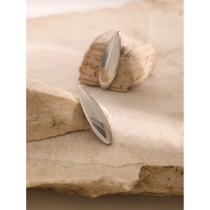 Minimalist silver teardrop earrings on natural stone showing elegant polished finish