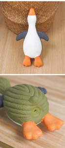 Detail of latex squeaky toy showing textured grooves and vocal device for small dogs