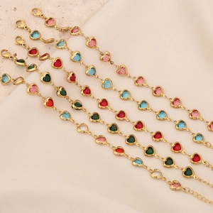 Detail of five gold chain bracelets with colorful heart-shaped crystal charms