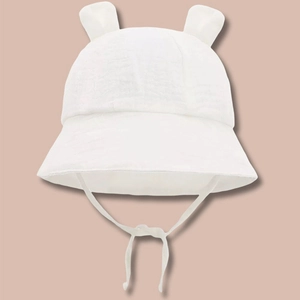 Detailed view of white cotton muslin baby sun hat with cute 3D ears and chin straps