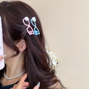 Detail shot of cute cat cartoon glasses hairpins in pink and blue on a model