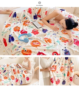 Close-up of thick flannel blanket with colorful cartoon monsters and soft velvet texture