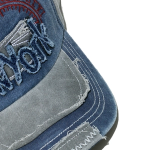 Detailed macro view of New York embroidery on washed vintage baseball cap with frayed edges