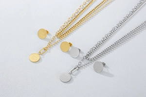 Close-up of gold and silver Good Luck necklaces and stud earrings jewelry set