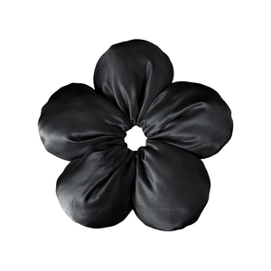 Detail shot of the glossy black silk five-petal flower hair scrunchie texture