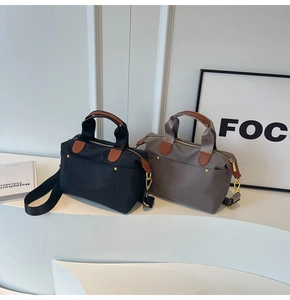Detail of waterproof nylon tote bags with leather handles and gold zippers in two colors