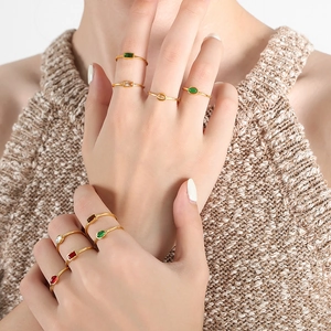 Minimalist gold plated titanium rings with colorful gemstones shown on fingers