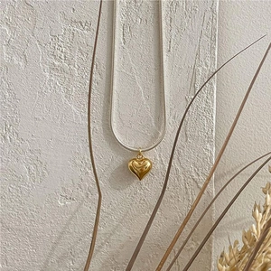 Minimalist 925 sterling silver snake chain necklace with a polished gold heart pendant