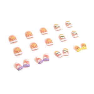 Colorful candy gradient press-on nails with rainbow and sun patterns for summer style