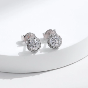 Elegant S925 sterling silver round moissanite stud earrings on white pedestal