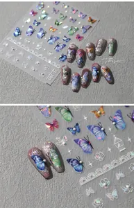 Close-up of TL-100 3D nail stickers featuring iridescent bows and lace patterns
