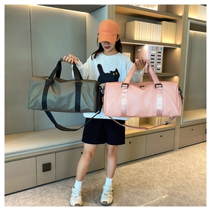 Pink and olive green gym bags shown in hand to compare large capacity and sizing