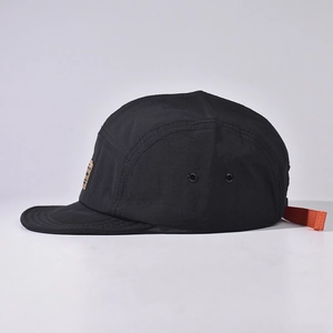 Black lightweight quick-dry five-panel camper hat with orange strap and side vents
