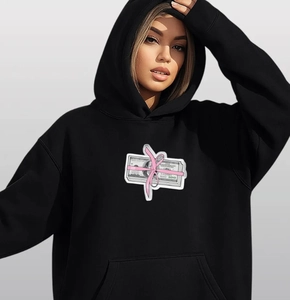 Close-up of black oversized hoodie featuring artistic pink ribbon dollar bill chest print