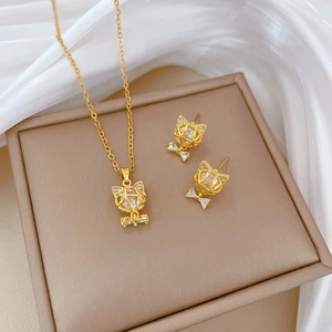 Titanium steel jewelry set with gold cat head and bow pendants inlaid with clear zircon