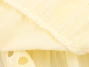 Detailed embroidery and quality seam finish on light yellow poplin cotton fabric