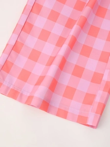 Detail shot of the pink and orange plaid fabric showing texture and pattern of the set