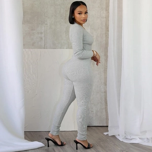 Side view of gray long sleeve ribbed bodysuit showing slim fit and textured fabric detail