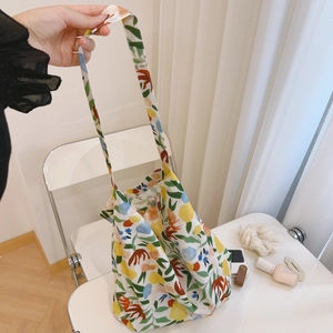 Detail view of large canvas tote bag featuring vibrant abstract floral print pattern