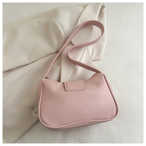 Elegante borsa sottobraccio rosa su blazer bianco con trama in pelle morbida