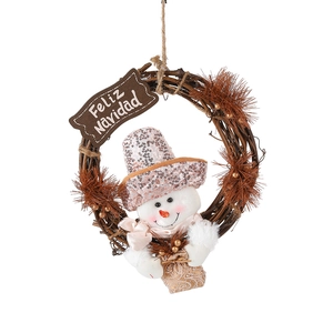 Christmas wreath with pink sequined snowman and Feliz Navidad wooden sign on grapevine base
