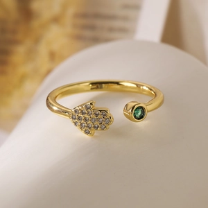 Gold-plated Hamsa hand open ring with sparkling cubic zirconia and emerald green stone