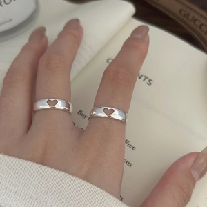 Detail of 925 sterling silver hollow heart rings on finger with minimalist design