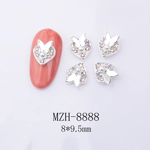 Macro shot of silver heart nail charms with central pearl and butterfly detail 8*9.5mm