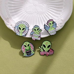 Set of five creative alien enamel pins with Stay Rad and Believe Yourself slogans