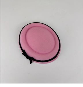 Detailed texture of pink wool felt beret with elegant black ribbon and small bow