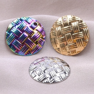 Detailed view of round woven texture metal pendants in rainbow, gold, and silver finishes